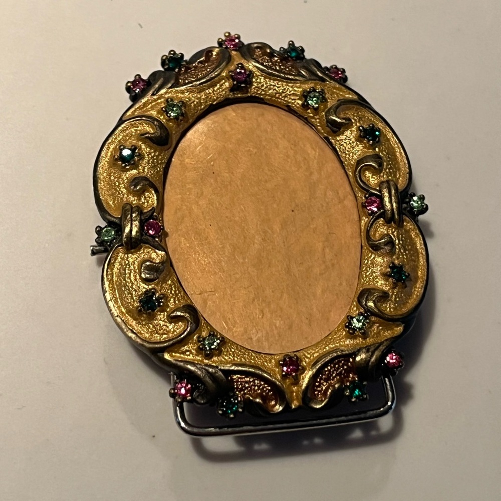 Beautiful rucinni frame adorned w/pink & green colored crystals.  Easel on back.